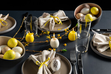 Wall Mural - easter, holidays, tradition and object concept - close up of dinner party table serving over black background