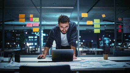 Poster - Successful Handsome Creative Director Working on Laptop Computer in Big City Office Late in the Evening. Businessman Preparing for a Marketing Plan in Conference Room.