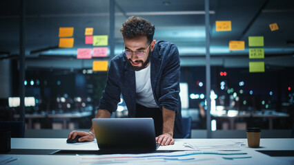 Poster - Successful Handsome Creative Director Working on Laptop Computer in Big City Office Late in the Evening. Businessman Preparing for a Marketing Plan in Conference Room.