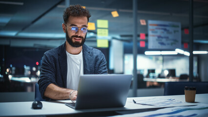 Poster - Successful Handsome Creative Director Working on Laptop Computer in Big City Office Late in the Evening. Businessman Preparing for a Marketing Plan in Conference Room.