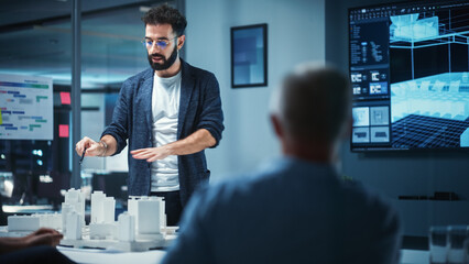 Poster - Creative Architect Holds Meeting Presentation of a New Housing Project for a Team of Real Estate Investors. Adult Male Uses TV Screen with Technical Drawings, 3D Renders and Engineering Plans