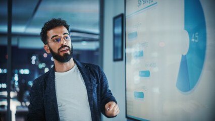 Aufkleber - Company Creative Manager Holds Sales Meeting Presentation for Employees and Executives. Hispanic Male Uses TV Screen with Growth Analysis, Charts, Ad Revenue. Work in Business Office.