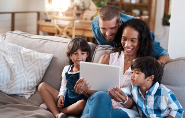 We found some online entertainment for the whole family. Shot of a family of four watching something on a digital tablet.