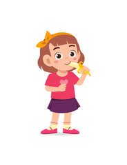 Wall Mural - little girl standing and eating fresh banana