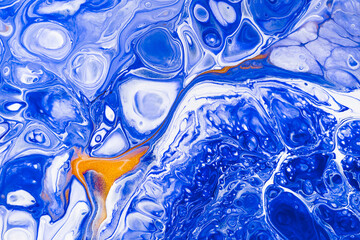 Wall Mural - Fluid art texture. Background with abstract swirling paint effect. Liquid acrylic artwork with flows and splashes. Mixed paints for posters or wallpapers. Blue, golden and white overflowing colors.
