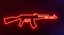Glowing Neon Line Weapon Gun Icon Isolated On Blue Background