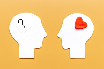 Communication and relationship concept - brain and heart on two paper human heads