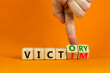 From Victim To Victory Symbol. Businessman Turns Wooden Cubes And Changes Concept Words Victim To Victory. Beautiful Orange Background. Business Support From Victim To Victory Concept. Copy Space.
