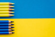 Top view of blue and yellow color pencils on ukrainian flag.