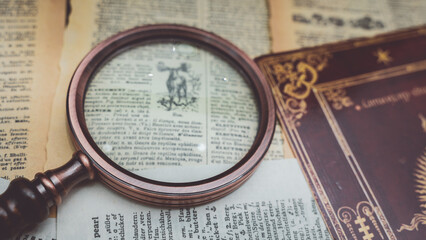 Wall Mural - Magnifying Glass On Old Book