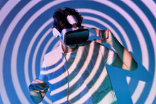 Man In VR Headset Near Wall With Lights