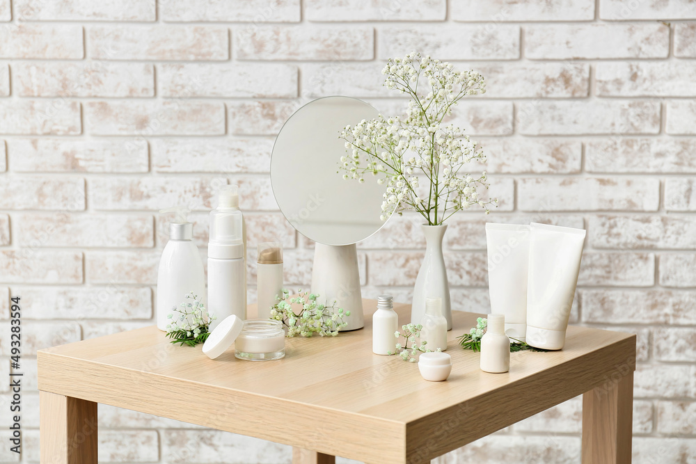 Different cosmetic products on wooden table