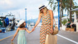 © Daniel Gonzalez/Stocksy - Stylish woman walking with daughter
