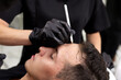 © Dmitry Borovikov/Stocksy - Plastic surgeon preparing for operation on man face