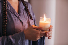 Anonymous Woman Holding Burning Candle