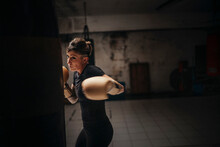 Focused Strong Woman Boxing In Gloves