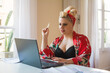 © Ana Luz Crespi/Stocksy - Woman paying the bills from home