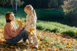© Sergey Narevskih/Stocksy - Mom and kid on sunny autumn day in park