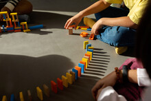 Kids Making Circuit With Wooden Dominoes 