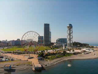 Beach promenade with a view of the ferris wheel and Alphabetic Tower from above in Batumi, Georgia