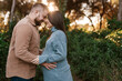 © Ezequiel Giménez/Stocksy - Loving ethnic couple expecting baby caressing in nature