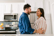© ByLorena/Stocksy - Expectant couple in love at kitchen
