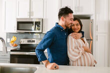 Excited Couple Expecting Baby In Kitchen