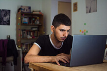 Young Latino Man At Home With Pc