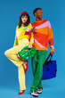 © BONNINSTUDIO/Stocksy - Fashionable couple in colorful wear