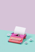 Pink Typewriter And Crumpled Papers
