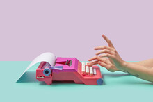 Writer Typing On Pink Vintage Typewriter