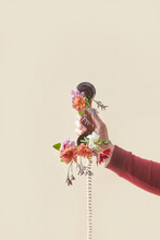 Man Holding Vintage Handset With Flowers