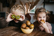 © Melissa Milis Photography/Stocksy - Two kids enjoying fruit