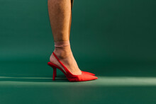 Man With Red High Heels On Green Background