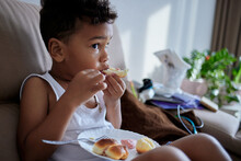 An African American Kid Eats Homemade Food