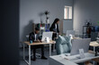 © Oleksii Syrotkin/Stocksy - Female colleague coming in and sitting to her workplace