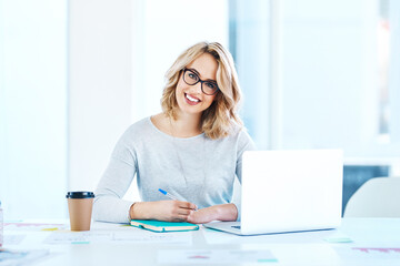 Poster - Challenge yourself to do better each day. Portrait of an attractive young businesswoman working on a laptop in an office.