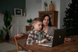 © Elena Kharichkina/Stocksy - Mother Helping Son with Homework.