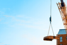 Mobile Crane Lifting Its Counterweight During Crane Assemling And Preparations On Building Site.