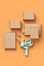 Cardboard Boxes And Scotch Dispenser On Orange
