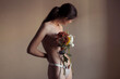 © Lucas Ottone/Stocksy - Nude woman with flowers