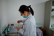 © Nicklaus Walter/Stocksy - Female Chinese doctor prepares medicine at a hospital