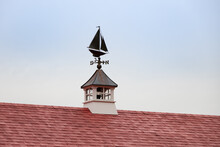 Sailboat-shaped Weather Vane With Blue Sky Background
