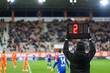 Team manager shows additional time - two minutes during football match.