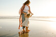 © Erin Brant/Stocksy - Mother and daughter on beach at sunset