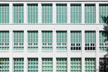 Geometric Patterns On The Windows Of A White Building