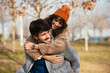 © BONNINSTUDIO/Stocksy - Gleeful couple having fun in autumn park