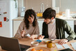 © BONNINSTUDIO/Stocksy - Serious couple paying bills at home