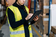 © Sergio Marcos/Stocksy - Crop Serious female worker using tablet in warehouse