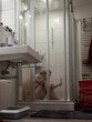 © Ksenia Krondo/Stocksy - Mental breakdown in shower with phone